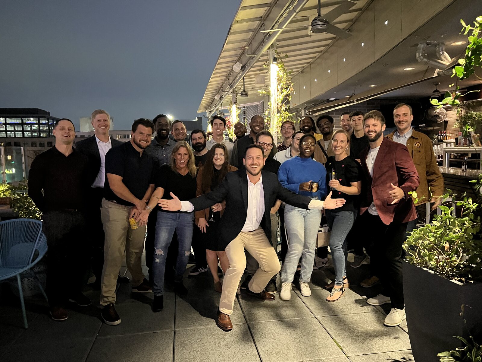 Tim Kinzie with a group of the people he trusts and builds with, on a rooftop at night